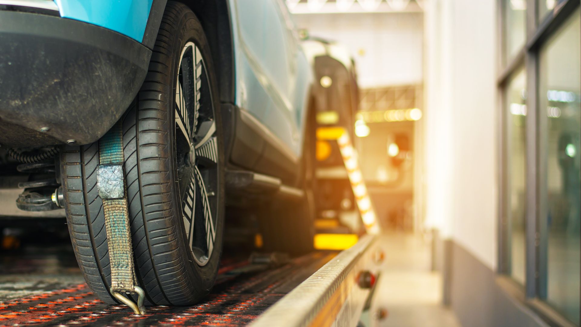 Close-up of car tire secured on vehicle lift in automotive service center